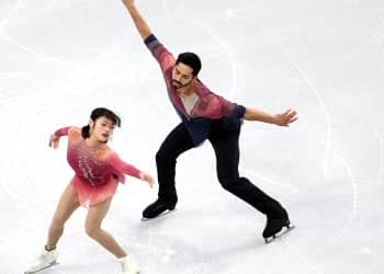 Not touching, arms extended to their sides, Emily Chan and Spencer Howe tell a story on the ice at Skate Canada International. 