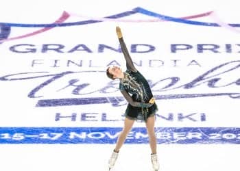 Dressed in black, arm to the sky, Sarah Everhardt skates over the on-ice Finlandia Trophy logo.