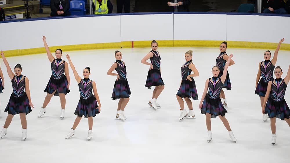 Collegiate synchronized skating team performs at a competition 