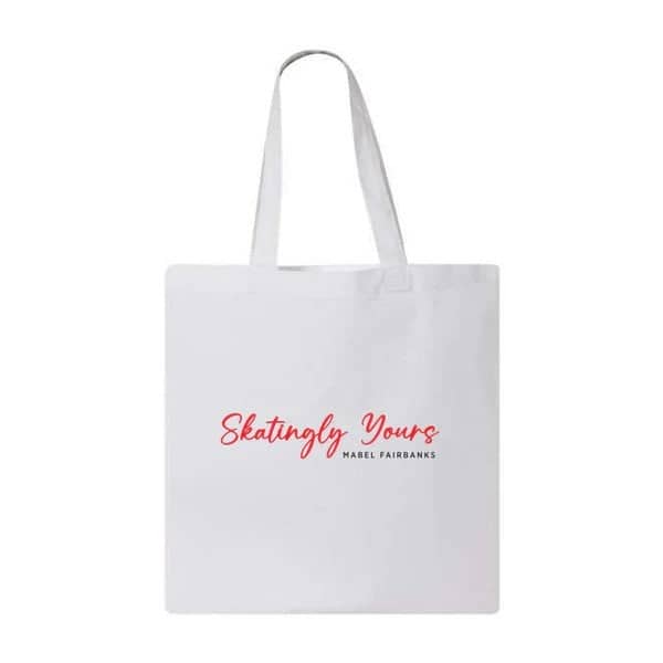 Image of a white tote bag with the words "Skatingly Yours" in red and the name "Mabel Fairbanks below it in black