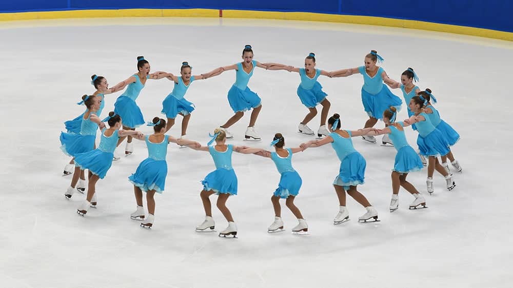 A juvenile synchro team performs a rotational element